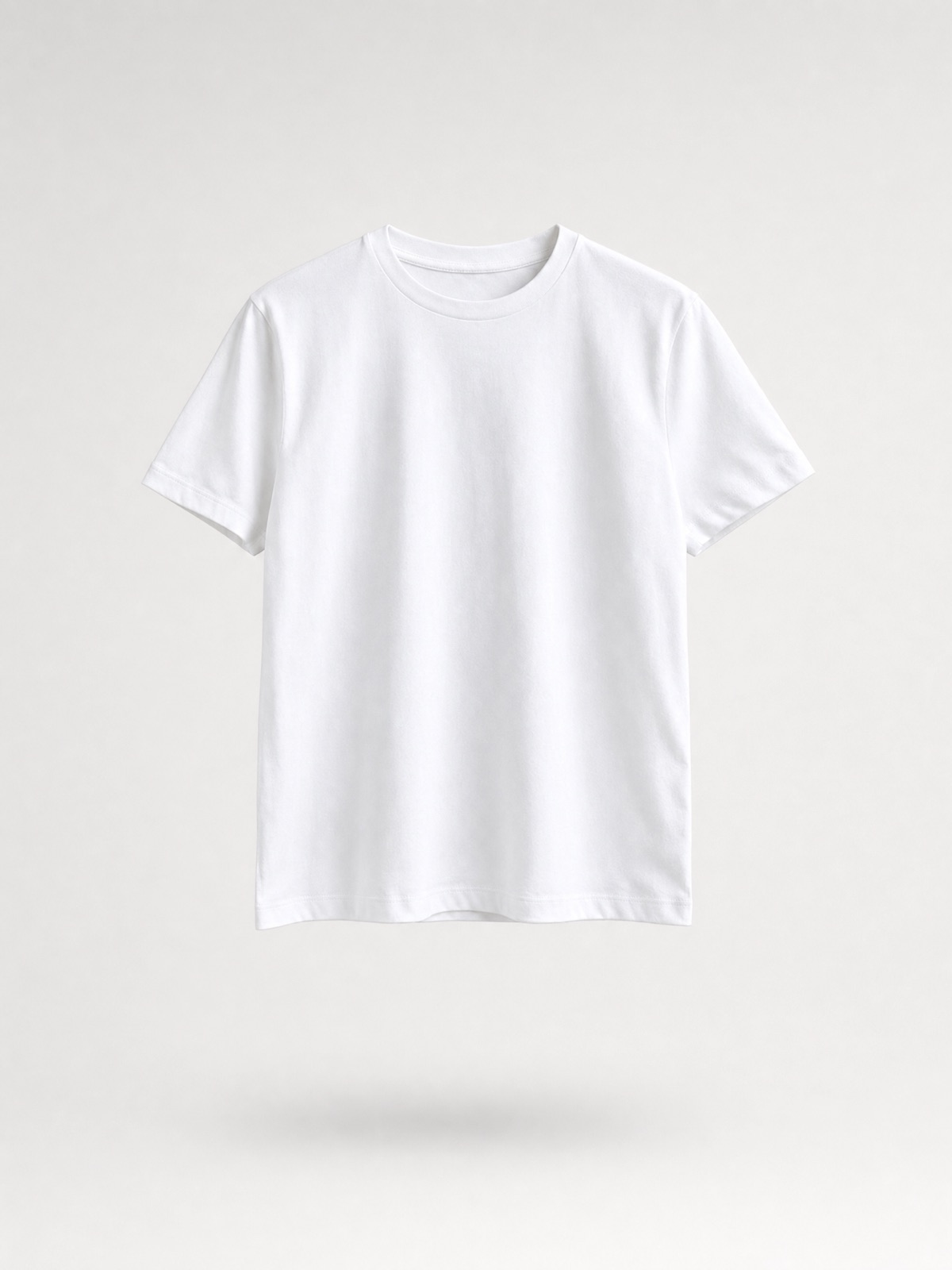 A white T-shirt floating dead-centre on soft grey